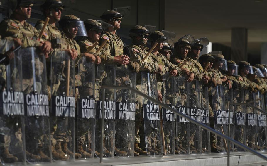 California National Guard members, with their shields, are positioned at the Federal Building in downtown Los Angeles, on June 10, 2025. 