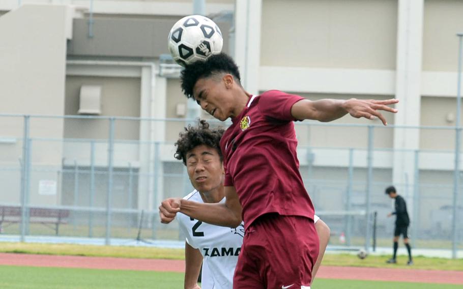 Matthew C. Perry’s Jalen Cooley heads the ball in front of Zama’s Thomas Diaz during Saturday’s DODEA-Japan boys soccer match. The teams played to a 1-1 draw.