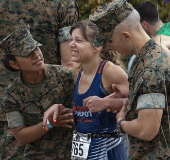 A runner is assisted at the finish line of the 48th Marine Corps Marathon on Sunday, Oct. 29, 2023, in Arlington, Va.