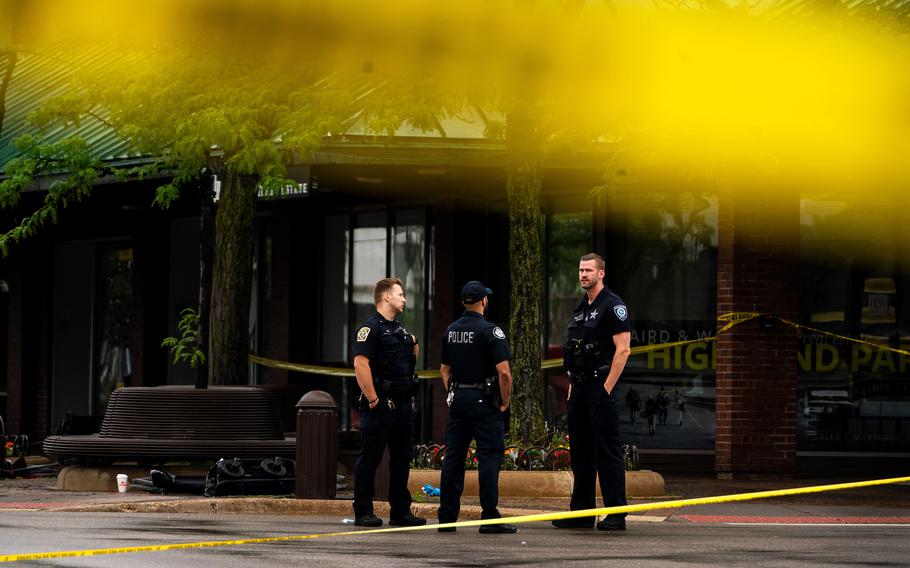 Police officers on July 6, 2022, near the scene of the July 4 mass shooting in Highland Park, Ill. 