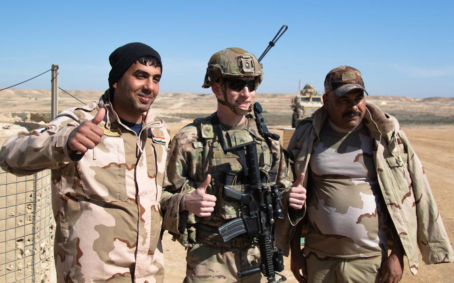 Iraqi and U.S. soldiers pose for a photograph along the perimeter of Al Asad Airbase in Anbar Province Feb. 14, 2020. The 25th ID regularly conducts presence patrols around the perimeter of Al Asad airbase to support Iraqi troops and strengthen the security partnership between the two nations. (U.S. Army photo by Sgt. Sean Harding)