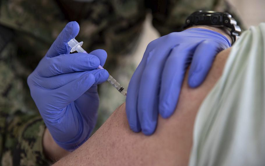 A COVID-19 vaccine is administered at Naval Station Norfolk in Virginia on April 8, 2021. 
