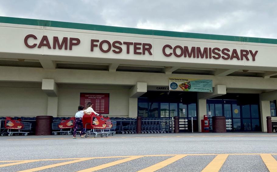 Children return an empty shopping cart outside the commissary at Camp Foster, Okinawa, Wednesday, Jan. 12, 2022. 