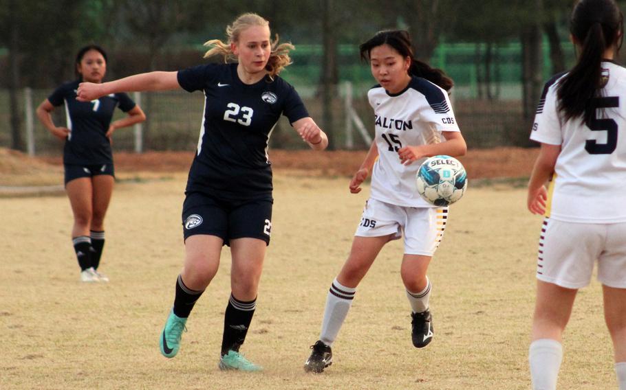 Osan's Kaysie Hendricks plays the ball past Cheongna Dalton's Chaewong Bang during Wednesday's Korea girls soccer match. The teams played to a 0-0 draw.