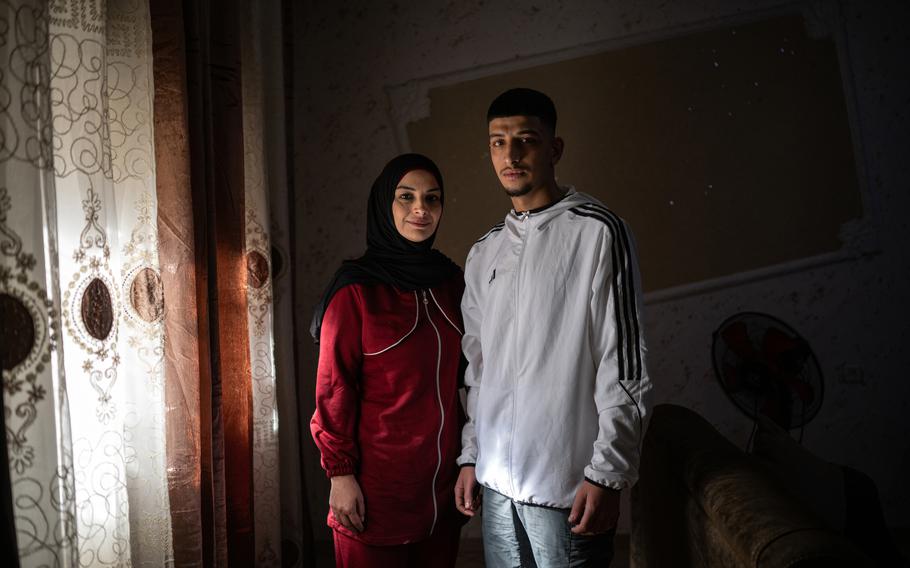 Malek Debeh, 17, with his mother, Nihal, 40, at their home in the Shuafat refugee camp in East Jerusalem on Thursday, Nov. 30, 2023.