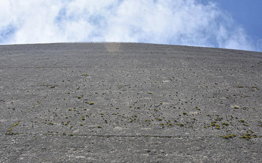 It's possible to walk down to the bottom of the Vajont Dam via a rocky path. Looking up, one can see the massive amount of concrete used to construct the structure, which has not been in use since the water was drained following the 1963 disaster that killed more than 1,900 people.