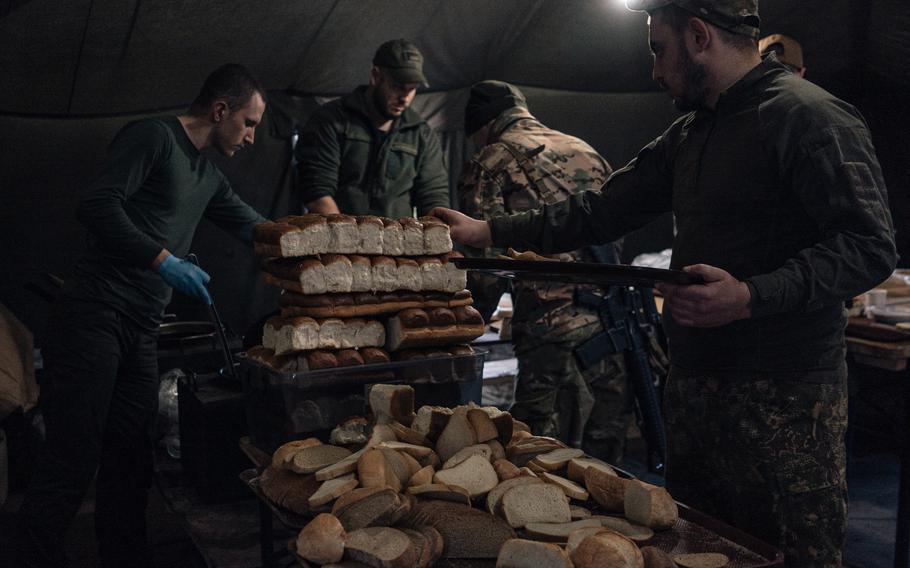 Men eat lunch at an Azov training facility outside Kyiv. 