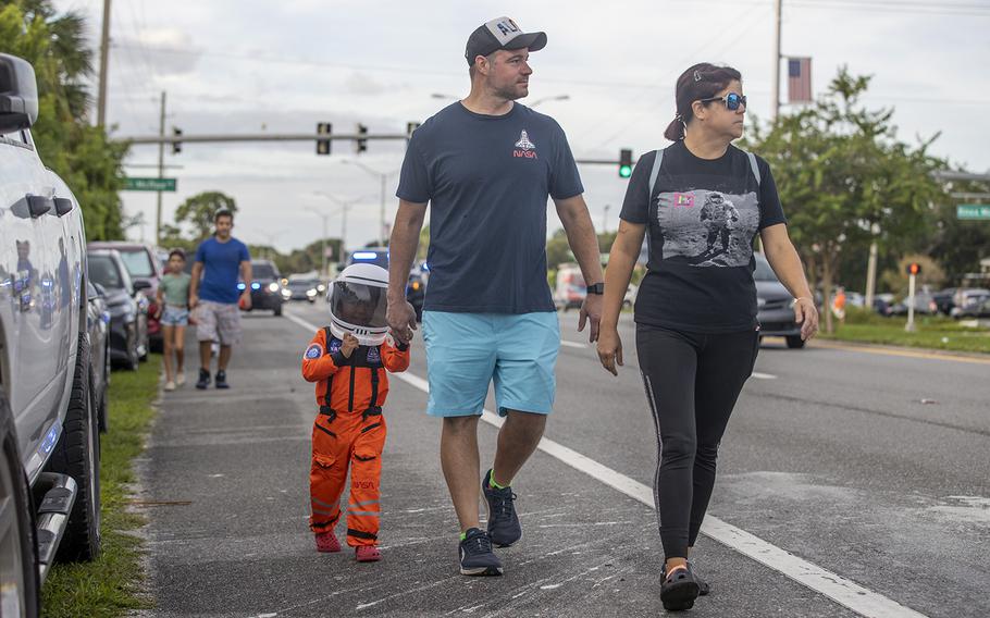 Nathaniel Lopez, 3, holds hands with his uncle, Ryan Lopez, 43, and his mother Angela Lopez, 43, outside Rotary Riverfront Park in Titusville. NASA scrubbed the launch of Artemis I following an engine issue.