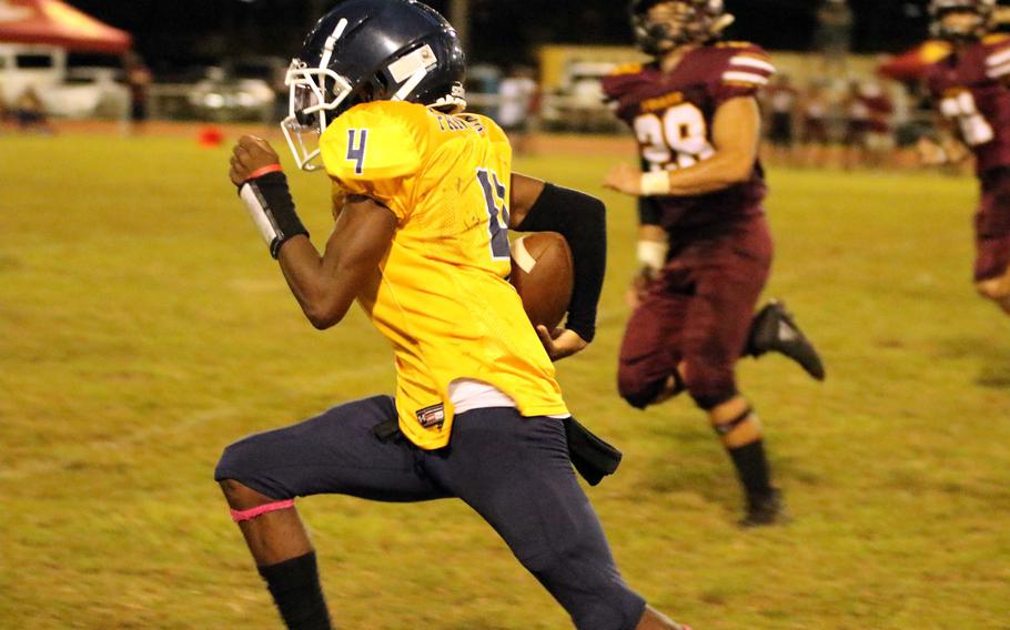 Guam High quarterback Aaron Johnson heads for the end zone on a 72-yard touchdown run.