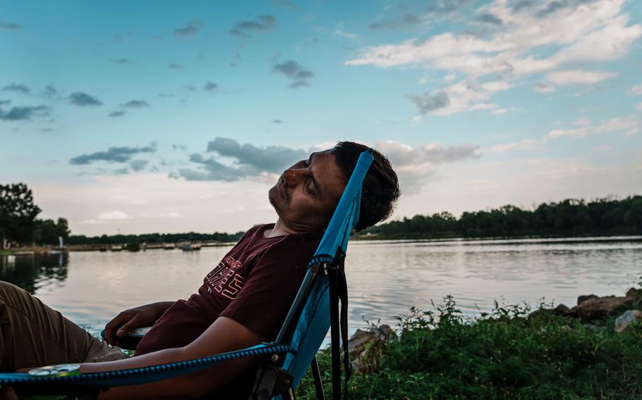 Shir Agha Safi, 30, relaxes at a park near Des Moines, Iowa, on Aug. 7, 2022. The former Afghan military commander is now a refugee eager to leave his war experiences behind. 