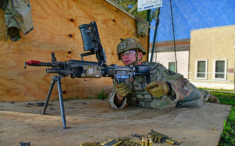 A U.S. Army paratrooper assigned to the 173rd Airborne Brigade prepares a M249 light machine gun for firing as part of the Expert Infantryman Badge, Expert Soldier Badge and Expert Field Medical Badge training at Caserma Del Din, Vicenza, Italy, Oct. 28, 2022. 
