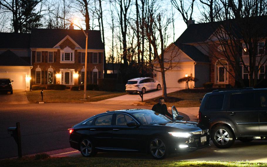 Khalid Payenda steps into his Honda outside his home in Woodbridge, Va. 