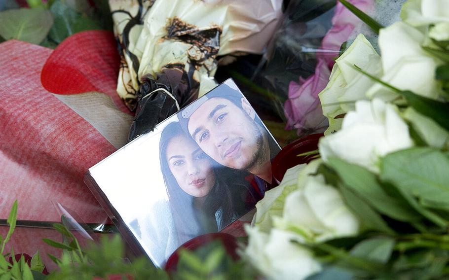 A picture of Bryce Fredriksz and his girlfriend Daisy Oehlers, who died on flight MH17, is surrounded by flowers at Schiphol airport in Amsterdam, on July 20, 2014. A Dutch court on Thursday, Nov. 17, 2022 is set to deliver verdicts in the trial of three Russians and a Ukrainian rebel for their alleged roles in the shooting down of Malaysia Airlines flight MH17.