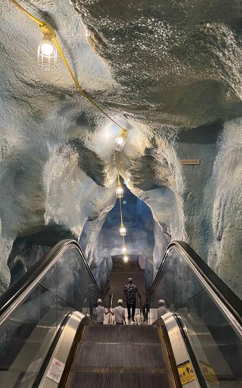 A walkway goes between walls that resemble fake glaciers.