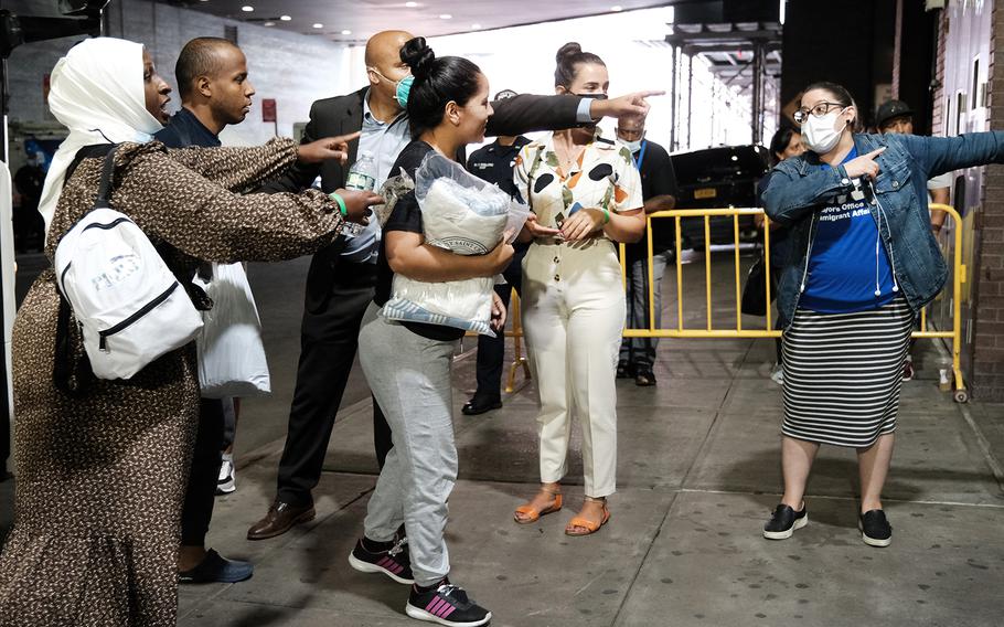 Migrants who crossed the border from Mexico into Texas exit a bus as it arrives into the Port Authority bus station in Manhattan on Aug. 25, 2022, in New York City.