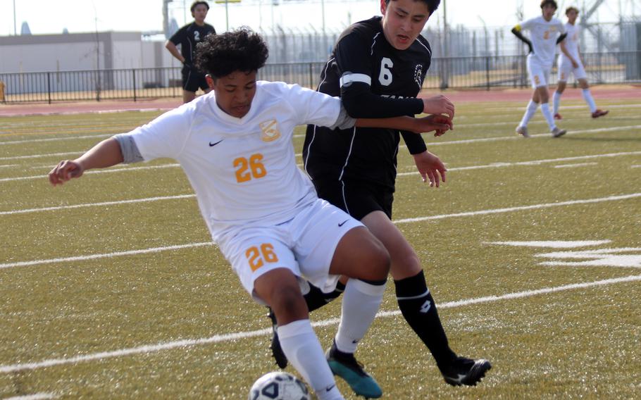 Yokota’s Jayden Royster and Zama’s Michael Gough battle for the ball during Saturday’s Perry Cup Bronze Group semifinal. The Trojans won 1-0 and added another win later to take seventh place. The Panthers finished ninth.