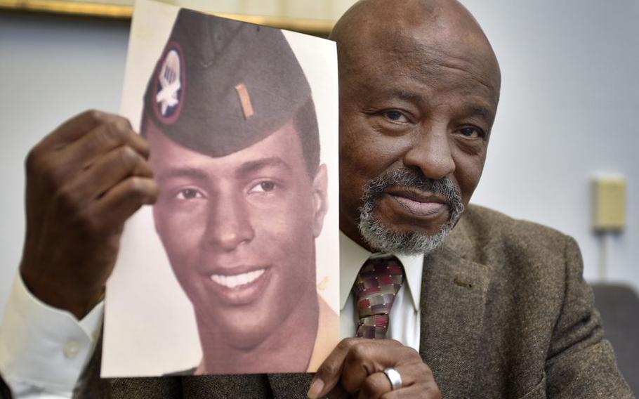 Local National Association for Black Veterans commander Tony Francis with a photograph from when he was 21 years old.