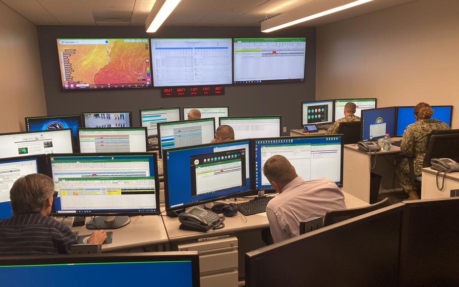 Staff members of the Navy's Maintenance Operations Center in Norfolk get their daily update on the status of all the Navy's E2 airborne reconnaissance planes.
