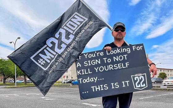 Air Force veteran Scot Northcutt often stands on Yokota Air Base, Japan, holding a sign with a jarring message: “If you are looking for a sign to not kill yourself today, this it is.” He spreads his message on behalf of Mission 22, an organization aimed at bringing awareness to veteran suicide. 