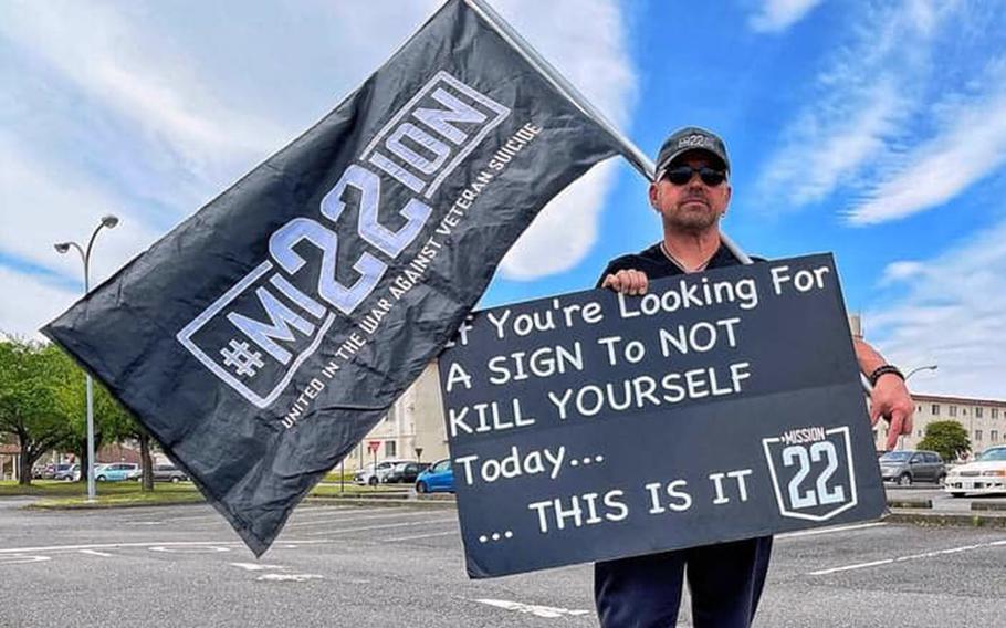 Air Force veteran Scot Northcutt often stands on Yokota Air Base, Japan, holding a sign with a jarring message: “If you are looking for a sign to not kill yourself today, this is it.” He spreads his message on behalf of Mission 22, an organization aimed at bringing awareness to veteran suicide. 