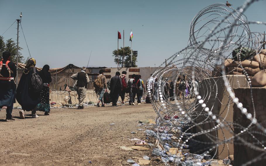 Evacuees walk to be processed during an evacuation at Hamid Karzai International Airport in Kabul, Afghanistan, on Aug. 25, 2021. According to reports on Friday, Sept. 10, Taliban fighters are carrying out extrajudicial executions of civilians in Panjshir province.