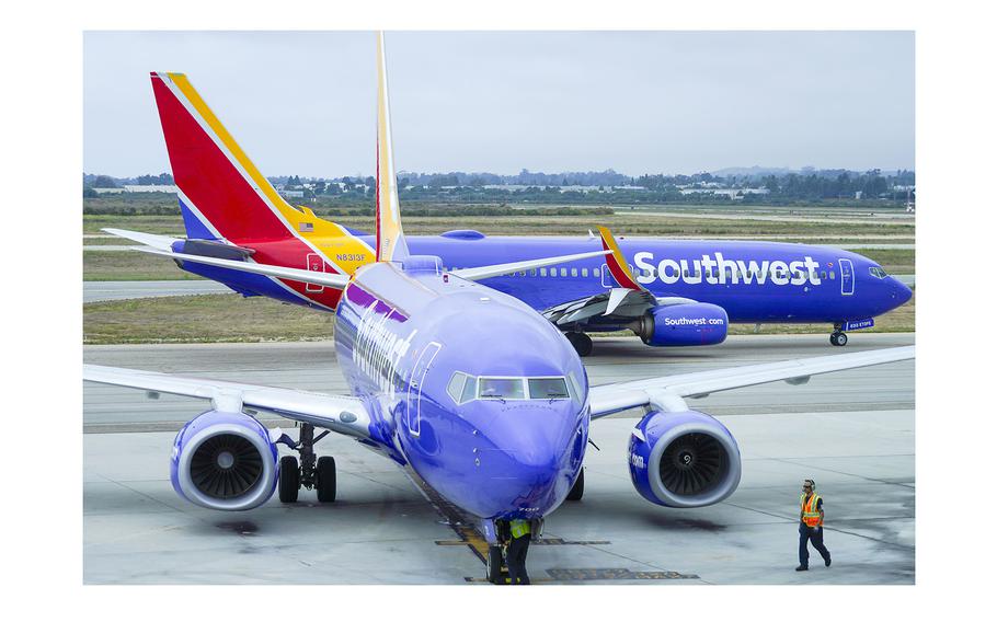 A Southwest Airlines plane is prepared to push back from the gate as another taxis toward a gate at Santa Barbara Municipal Airport on Aug. 11, 2023, in Santa Barbara, Calif.