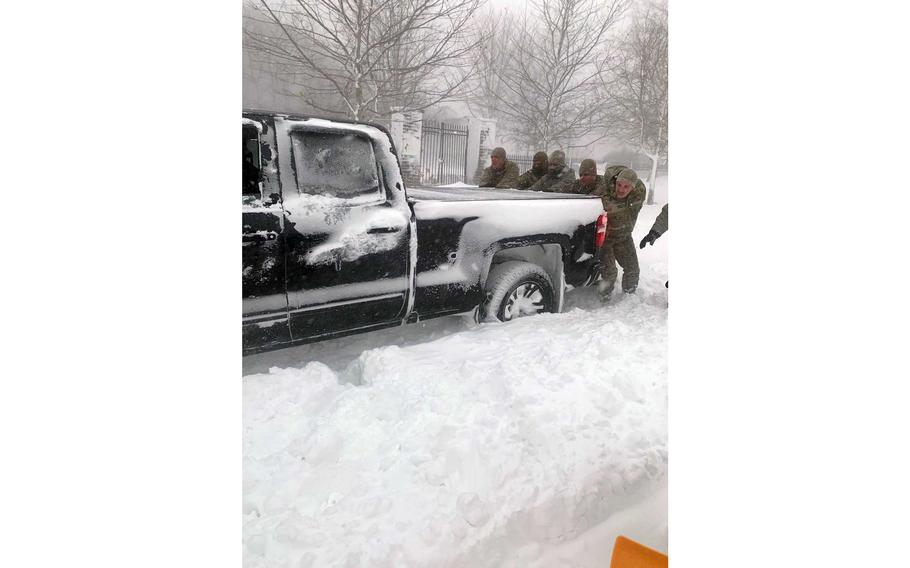 New York Air National Guard airmen assigned to the 107th Attack Wing at Niagara Falls Air Reserve Station assist motorists stuck in high snow drifts near Buffalo, N.Y., Dec. 25, 2022. 