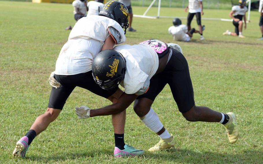 Kadena's A.J. Webster and Nathaniel Bahena engage in a tackle drill.