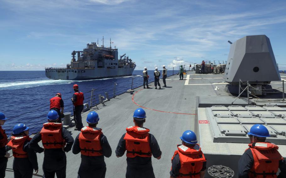 The guided-missile destroyer USS Dewey pulls alongside the Lewis and Clark-class dry cargo ship USNS Wally Schirra in the Philippine Sea, Sept. 20, 2023.