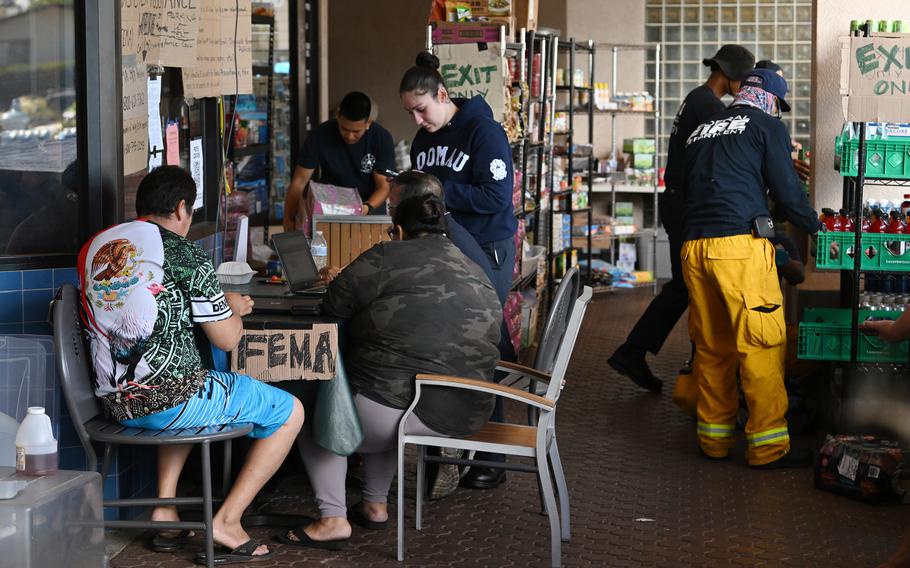 Families fill out paperwork for FEMA relief at Napili Plaza on Aug. 17, 2023, in Napili, Hawaii. 