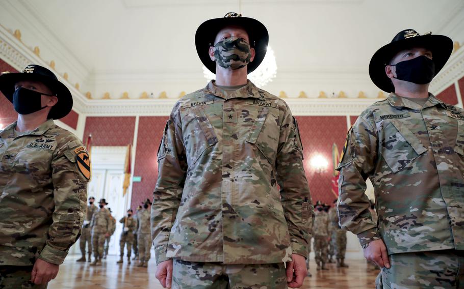 Brig. Gen. Brett Sylvia, acting commander, 1st Cavalry Division, stands between Col. Ryan M. Hanson, left, outgoing commander and Col. Jon W. Meredith, incoming commander, 1st Armored Brigade Combat Team, during the assumption of command ceremony in Zagan, Poland, May 14, 2021.

Christopher ''Ham'' Hammond/U.S. Army