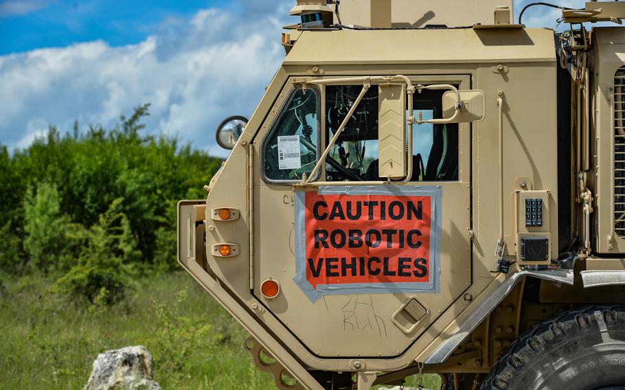 The unmanned driver's cabin remains empty while an autonomous transport vehicle moves past demonstration attendees at the Joint Multinational Readiness Center, in Hohenfels, Germany, June 8, 2022. The truck has been converted from a traditional palletized load system to allow for driverless convoy operation. 