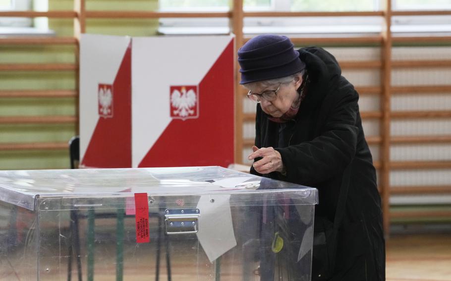 A woman casts her ballot in Poland.