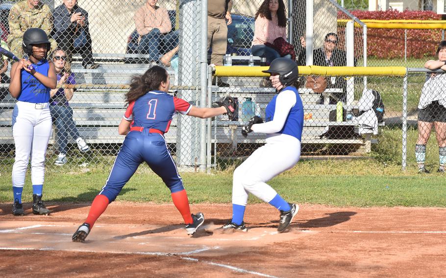 Aviano's Sophia Scavo tags out Hohenfels' Tyleigh Shamoon before she can get to home plate after a wild pitch on Friday, April 28, 2023.