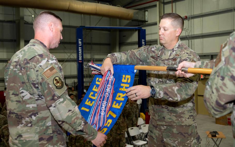 Air Force Col. Matthew Beverly cases the colors with Col. Christopher Stanmire, commander of the 557th Expeditionary Rapid Engineer Deployable Heavy Operational Repair Squadron Engineers, or “Red Horse,” at Al Udeid Air Base, Qatar, on Oct. 15, 2022. 