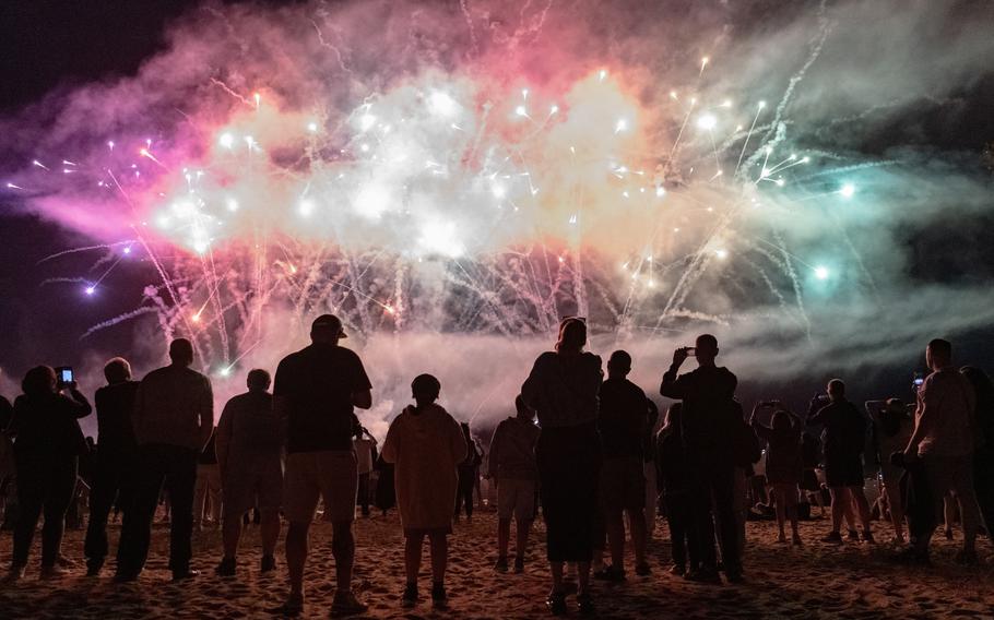 Spectators watch a massive fireworks display.
