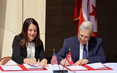 Natasha Franceschi, the U.S. Embassy Tunisia chargée d’affaires, and Tunisian Foreign Minister Othman Jerandi sign a memorandum at the North Africa American Cemetery in Carthage, Tunisia that will allow for the repatriation of unknown U.S. troops buried at the cemetery. 