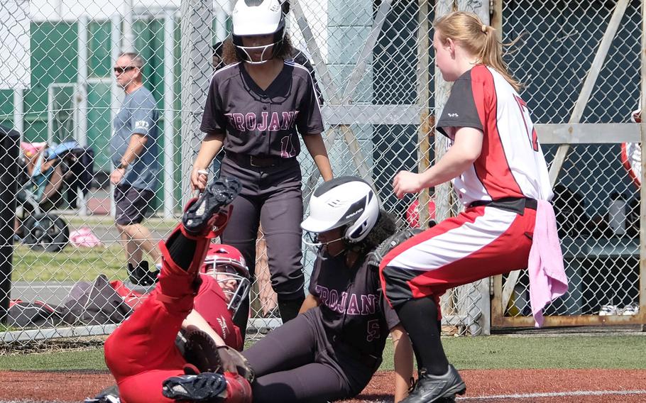 Nile C. Kinnick’s Maria Pidgeon tags out Zama’s Bonnie Jones at the plate during Friday’s playoff game in the All-DODEA-Japan softball tournament. The Red Devils outlasted the Trojans 20-14 in a game that took more than three hours.