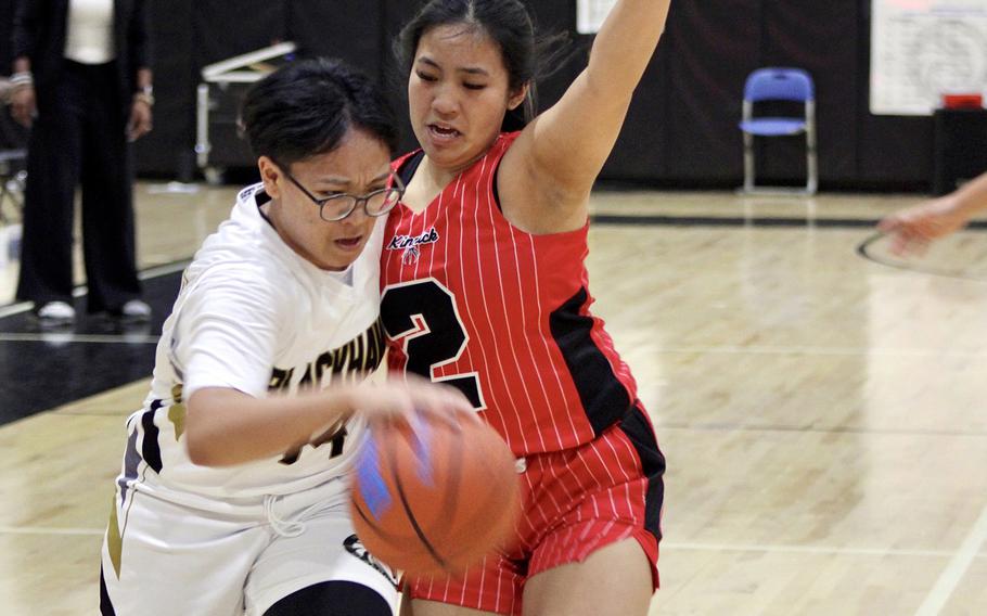 Humphreys' Stephanie Gabriel drives against Nile C. Kinnick's Mikaila Joi Miranda during Monday's Far East Girls Division I round-robin game, won by the Blackhawks 40-33.