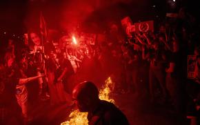 Demonstrators burn fire during a protest against Israeli Prime Minister Benjamin Netanyahu's government, and calling for the release of hostages held in the Gaza Strip by the Hamas militant group, in Tel Aviv, Israel, on May 26, 2024.