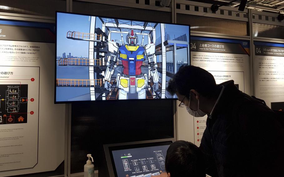 Visitors to Gundam-Lab Academy, part of the Gundam Factory in Yokohama, Japan, learn about the RX-78F00, the first General Purpose Utility Non-Discontinuity Augmentation Maneuvering Weapon System, or Gundam.