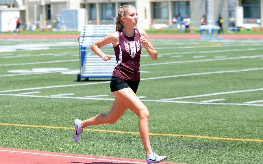 Jane Williams runs on the track.