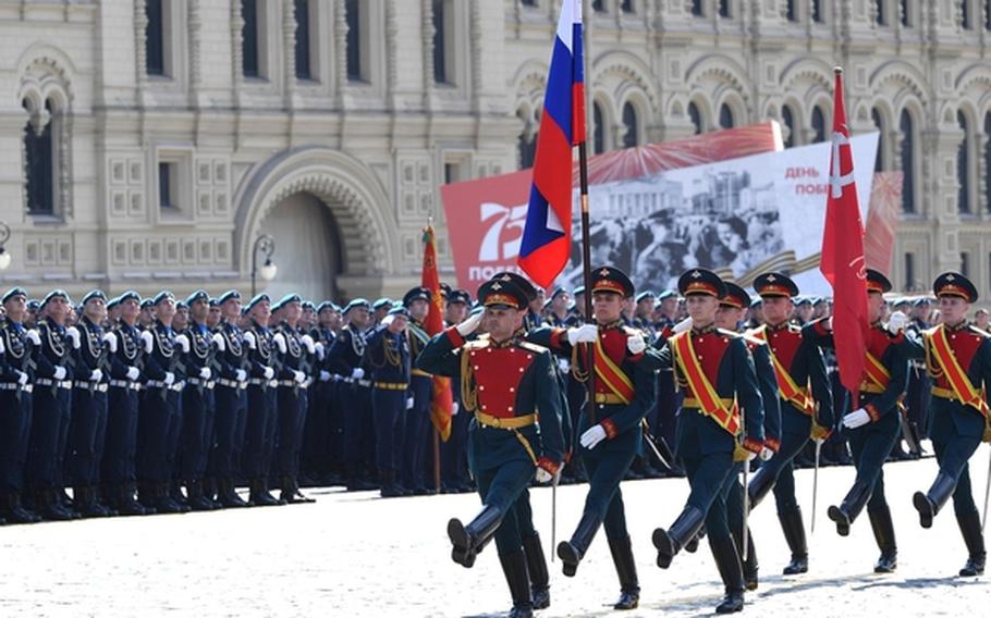 Russian soldiers march in a military parade.