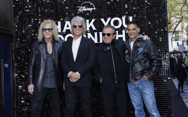 From left, David Bryan, Jon Bon Jovi, Tico Torres and Gotham Chopra pose for photographers upon arrival at the premiere of the film “Thank You, Good Night: The Bon Jovi Story,” in London on April 17. The docuseries debuts on Hulu Friday.