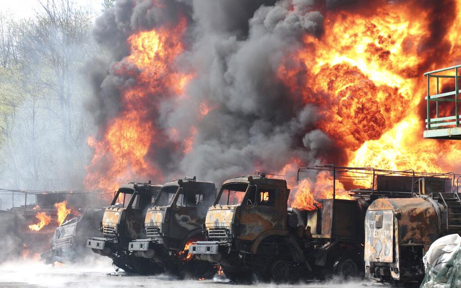 Vehicles are on fire at an oil depot after missiles struck the facility in an area controlled by Russian-backed separatist forces in Makiivka, eastern Ukraine, on May 4, 2022. According to reports on June 15, Russian missiles destroyed an ammunition depot in Lviv, western Ukraine.