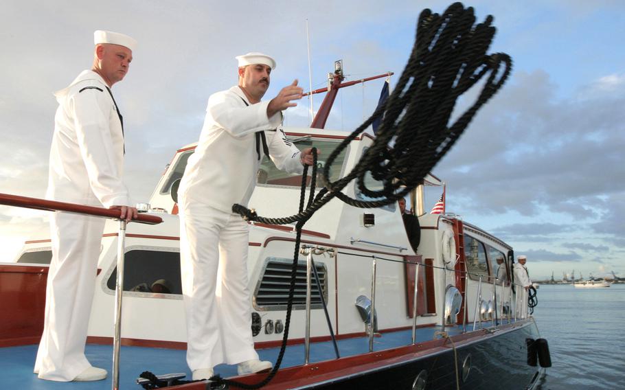 The admiral’s barge moors at the USS Arizona Memorial during the 62nd commemoration of the Dec. 7, 1941, attack on Pearl Harbor on Dec. 7, 2003. A 2019 fire that started in an electrical power area resulted in its total loss, damaged two other VIP boats and cost nearly $1.7 million in repair and replacement costs, the Navy said.