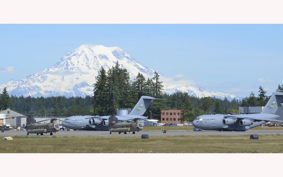 Aircraft are seen at Joint Base Lewis-McChord with Mt. Rainier in the background.