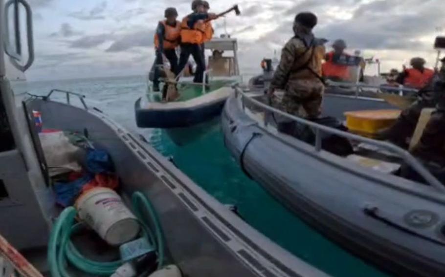 A screenshot posted on X by the Philippine military purports to show Chinese coast guard personnel intercepting a Philippine resupply mission in the South China Sea on June 17, 2024.