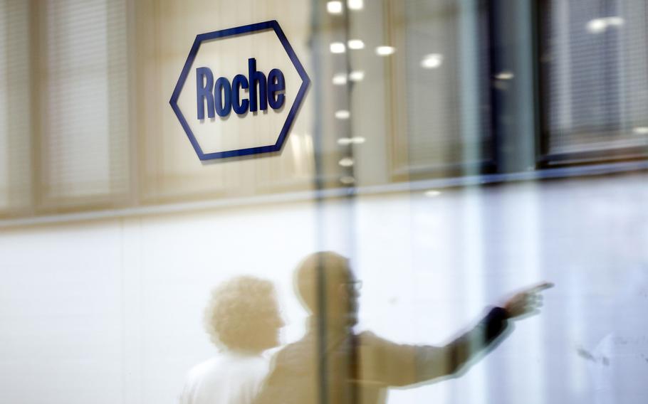 A company logo hangs on the wall at the Roche Holding headquarters in Basel, Switzerland, on April 26, 2018.