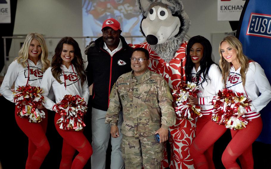 Staff Sgt. Hector Hernandez of the 66th Transportation Company, center, poses with former Kansas City Chiefs running back Christian Okoye, center left, team mascot K.C. Wolf and Chiefs cheerleaders on Nov. 2, 2023, at Ramstein Air Base, Germany. Hernandez won a pair of tickets to see the Chiefs face the Miami Dolphins on Nov. 5 in Frankfurt.